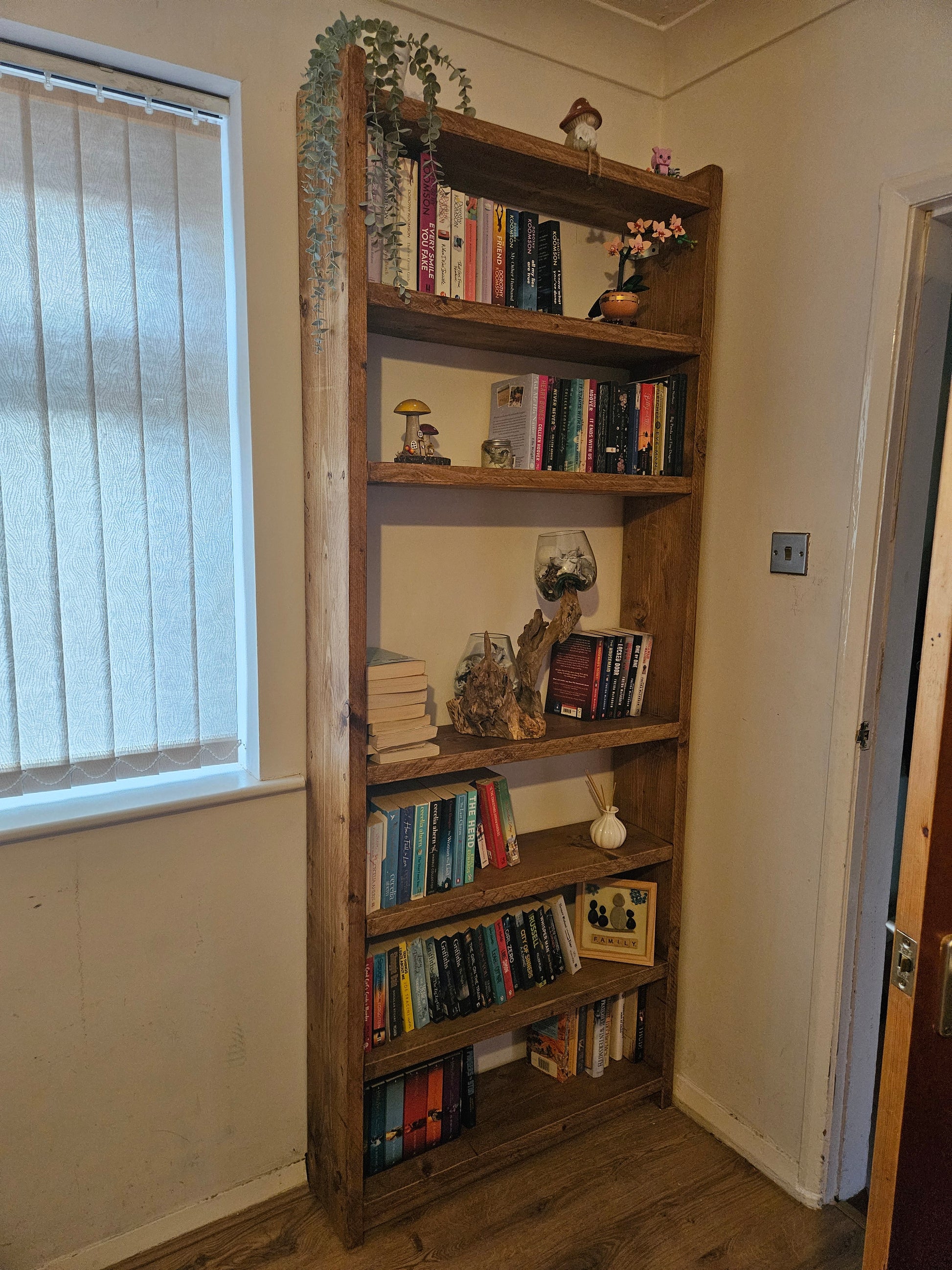 Bespoke floor to ceiling bookcase. Made from reclaimed pine in a rustic stripped pine finish