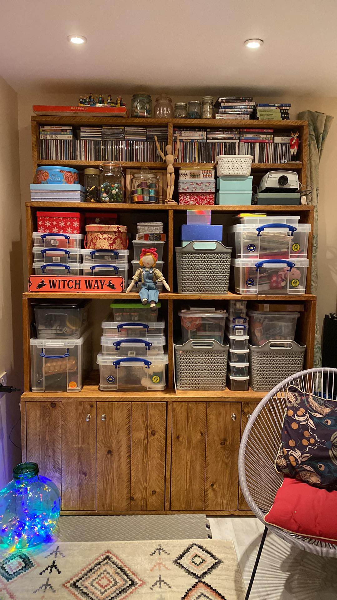 Large freestanding bookcase and cabinet with varied sized shelving and a cupboard underneath.
